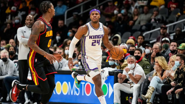 Jan 26, 2022; Atlanta, Georgia, USA; Sacramento Kings guard Buddy Hield (24) dribbles up the court against Atlanta Hawks guard Delon Wright (0) during the game at State Farm Arena.